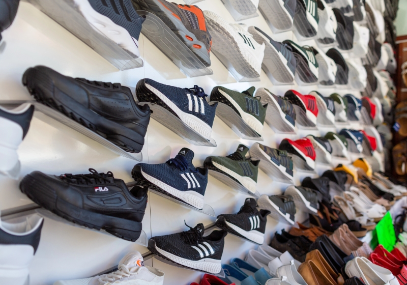 Wall of trainers in a sports shop.